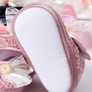 Pink soft sole baby girl walker shoes with anti-slip white dots and elegant lace details