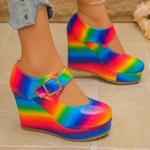 Detail view of vibrant rainbow platform wedge Mary Jane shoes with a glossy finish