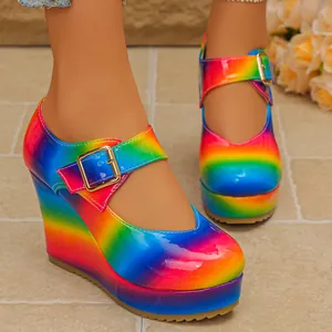 Close-up of rainbow gradient platform wedge shoes with Mary Jane strap and gold buckle