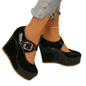 Black patent leather Mary Jane platform wedge shoes with square toe and buckle strap.