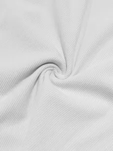 Macro detail of white corduroy fabric texture showing fine vertical ribbed pattern and soft feel