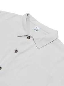 Detail of men's grey corduroy shirt showing collar, buttons and 100% polyester label