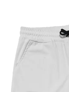 Close-up detail of white corduroy pants showing elastic waistband and drawstring