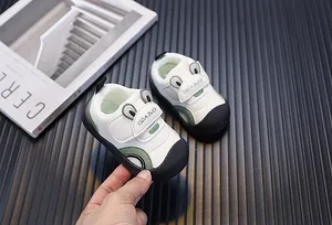 Detail of breathable mesh baby walking shoes with cute frog design and velcro strap