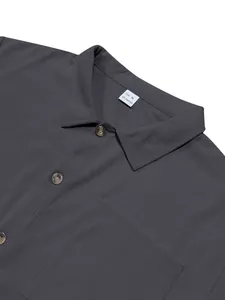 Detail view of grey corduroy men's shirt with lapel collar and buttons