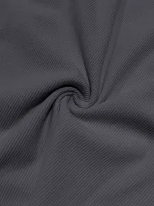 Detailed close-up of dark grey corduroy fabric showing high-quality ribbed texture