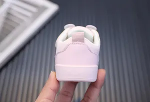 Close-up of the heel part on pink breathable toddler sneakers with soft soles.