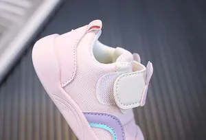 Detailed view of pink breathable mesh toddler shoes with adjustable hook and loop strap.