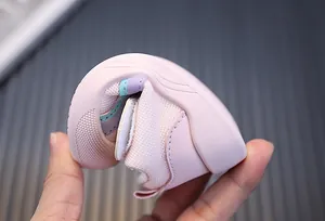 Close-up showing the flexible soft sole of a pink breathable mesh baby walking shoe