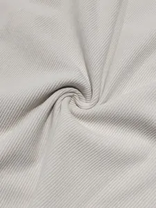 Macro view showing the soft texture of premium beige corduroy fabric for men's suit