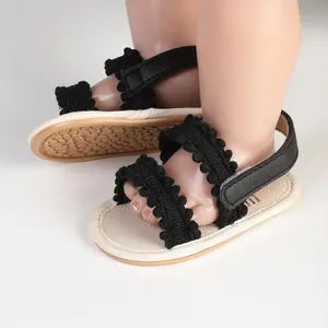 Nahaufnahme der schwarzen Baby-Sandalen mit Rüschen und verstellbaren Riemen