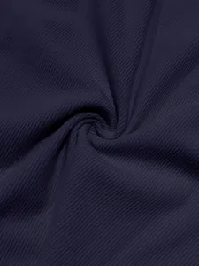 Close-up macro view of premium dark navy corduroy fabric texture for men's casual set