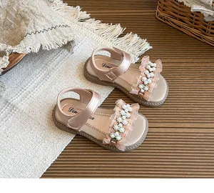 Close-up of children's pink princess sandals with pearl and flower mesh detailing