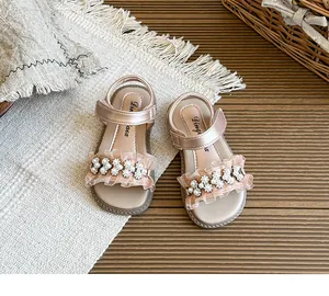Elegant pink children's sandals with pearls and ruffle details for summer