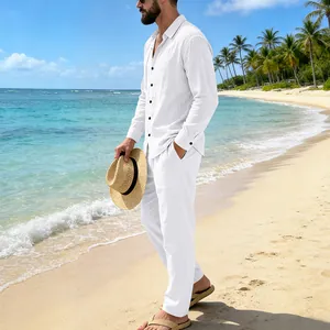 Caucasian male model wearing a white loose linen shirt and pants set on a sunny beach