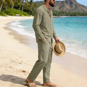 Full-length view of a men's sage green linen shirt and pants set on a sunny beach