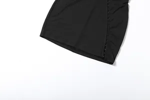 Close-up of black bodycon dress featuring metallic hook-and-eye closure detail