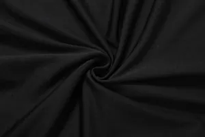 Close-up macro view of premium black stretch fabric showing smooth knit texture and folds.