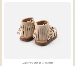 Back view of beige toddler sandals featuring stylish fringe and convenient zipper
