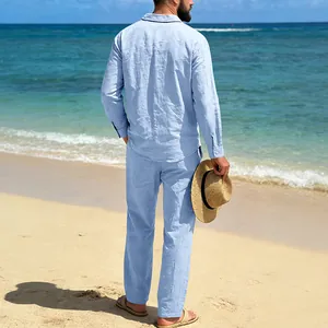 Detailed back view of men's light blue linen leisure suit on a sunny tropical beach.