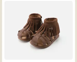 Macro detail of toddler brown fringed Roman sandals for girls with soft sole and side zipper