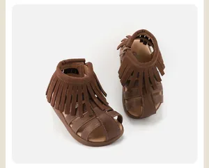 High-quality detail shot of brown toddler fringe sandals with a stylish Roman caged design