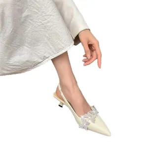 Elegant cream pointed toe slingback kitten heels featuring sparkling rhinestone butterfly details.