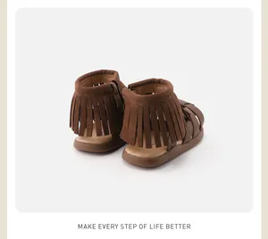 Detail of brown children's fringe sandals with side zipper and non-slip soft sole