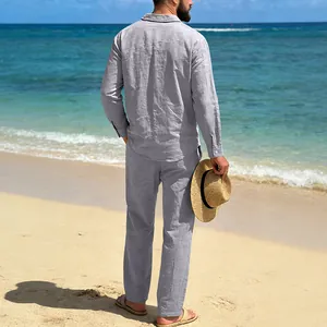 Back view of a man in a grey linen beach set, including a long-sleeved shirt and pants.