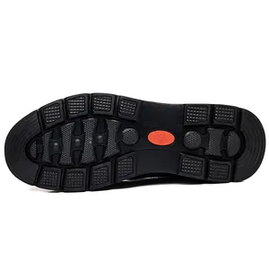Close-up macro view of the durable non-slip black rubber sole detail for men's leather snow boots