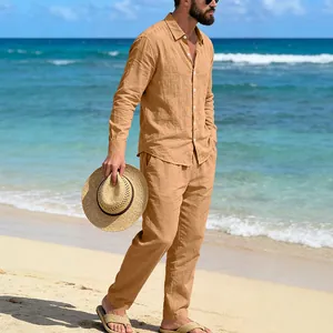 Full view of men's tan linen long-sleeve shirt and straight pants set on a sunny beach