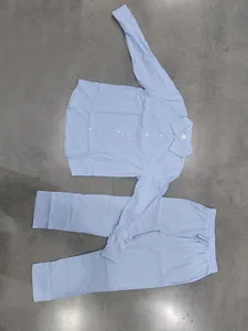 Light blue men's long-sleeve linen shirt and matching straight-leg trousers set laid flat.