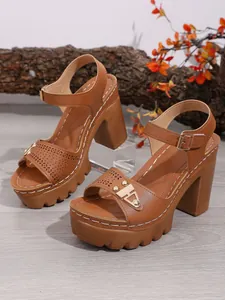Detailansicht brauner Plateau-Sandalen mit klobigem Absatz und Laserschnitt