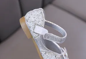 Gros plan des détails de strass argentés sur les chaussures plates de princesse pour fille