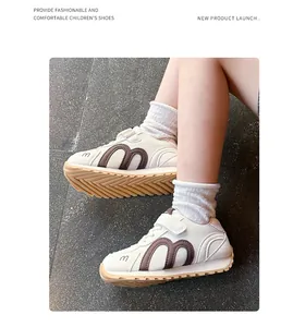 Close-up of fashionable breathable mesh children's sneakers with ripple sole and m logo.