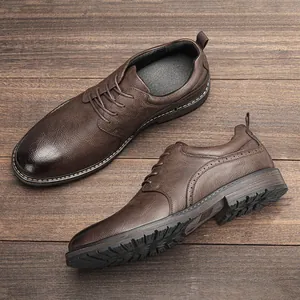 Detailed close-up of men's brown polished leather dress shoes with brogue detailing