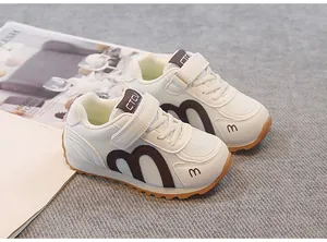 Breathable white mesh children's sneakers with brown accents and durable gum sole.