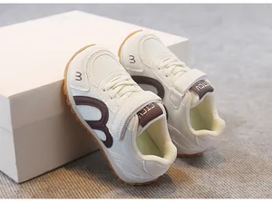 Close-up detail of breathable mesh children's sneakers with Velcro strap and retro design