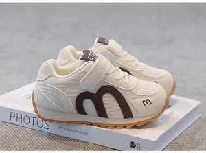 Detailed view of breathable mesh kids' sneakers in cream and brown
