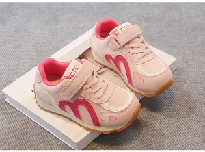 Close-up of pink breathable mesh sneakers for girls with Velcro straps and m-logo