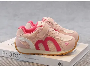 Pink breathable mesh kids sneakers with M-pattern design on a fashion book