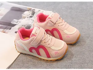 Detailed side view of pink breathable mesh sneakers for girls with secure Velcro straps
