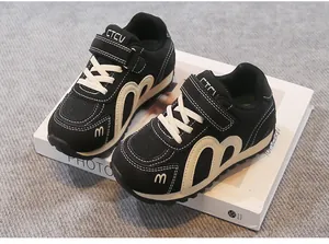 Detail view of breathable black mesh children sneakers with convenient velcro strap