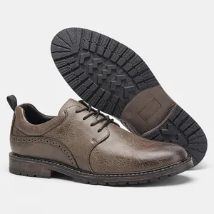 Close-up view of brown textured leather men's shoes featuring non-slip rubber soles