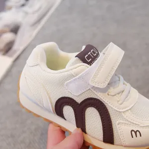 Breathable mesh children's sneakers in cream and brown with secure Velcro strap closure