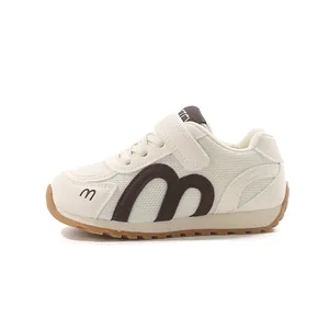 Breathable white children's mesh sneakers featuring a classic brown M logo design