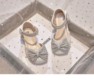 Glittery gold girls' princess sandals with large rhinestone bow and pearl strap