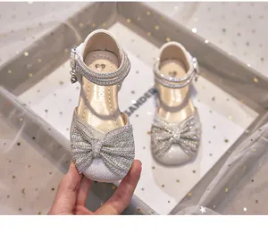 Detailed view of glittery girl's princess shoe featuring a large rhinestone bow