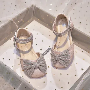 Girls' pink glitter princess sandals featuring a sparkling rhinestone bow and ankle strap