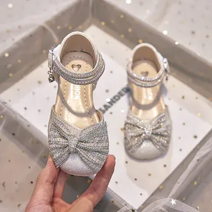 Elegant silver sparkly girls princess sandals featuring a large pearl bow and soft sole